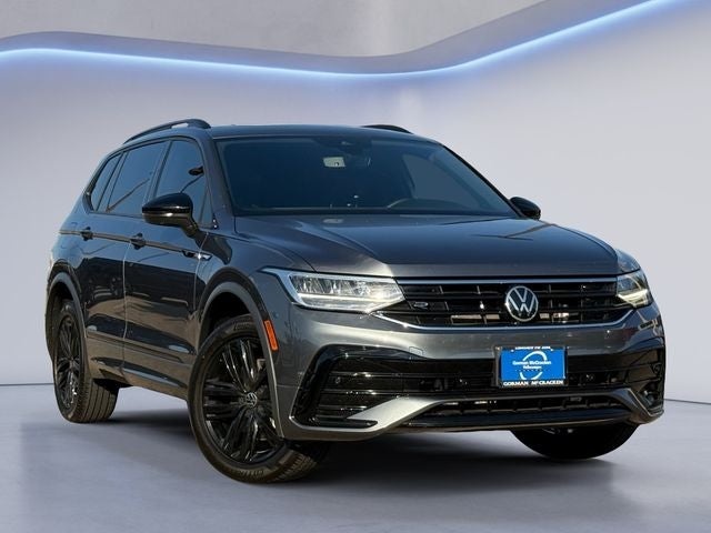 2025 Volkswagen Tiguan parked in studio setting, front-side view