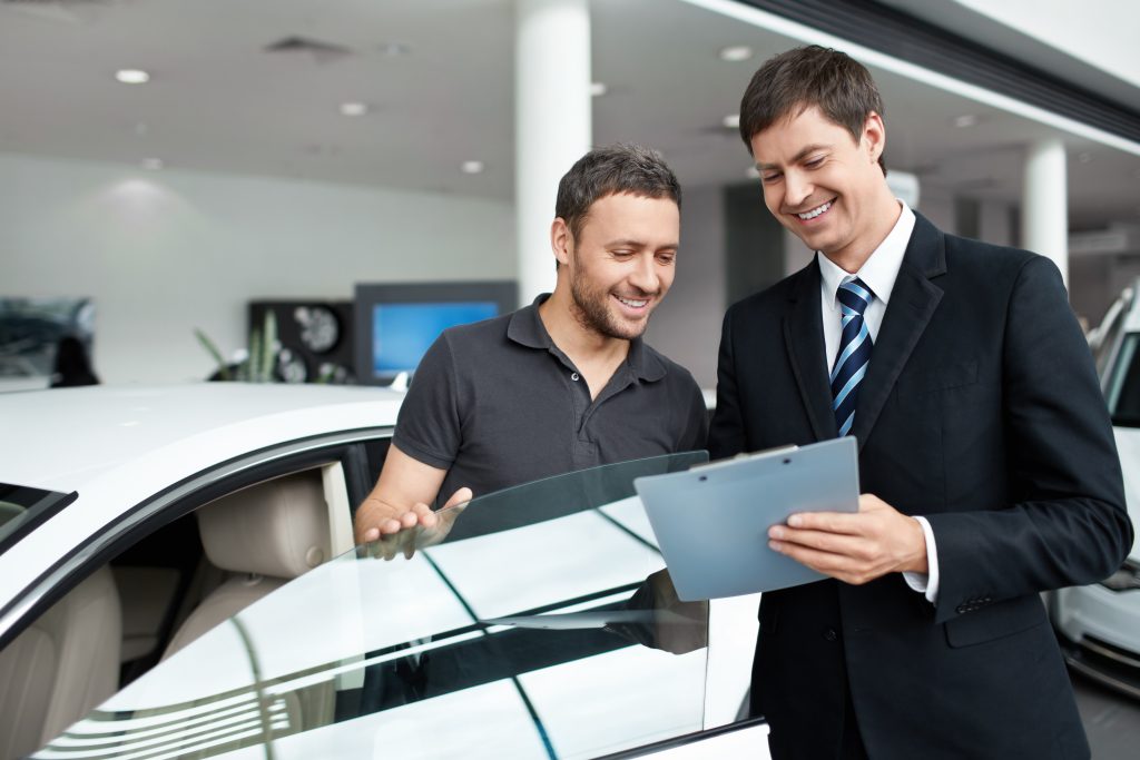 Customer discussing vehicle details with a dealership representative.
